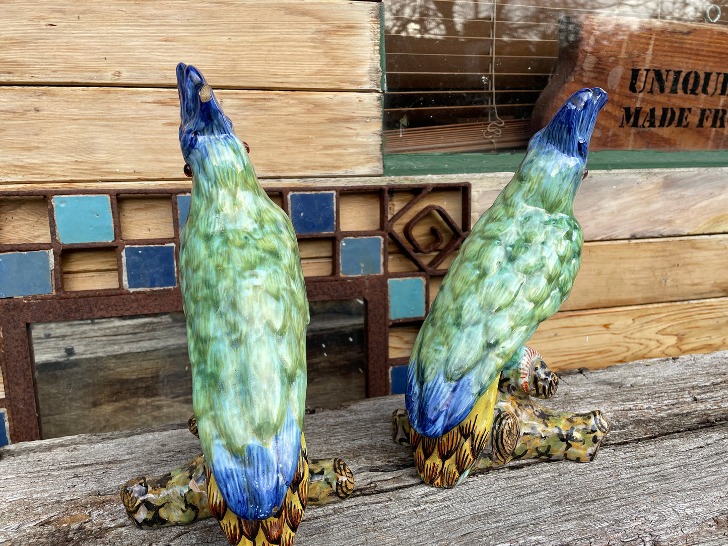 Pair of antique continental faience signed ceramic parakeets 26cm tall
