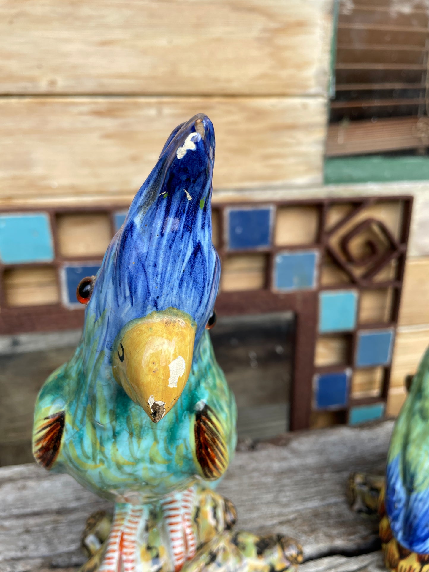 Pair of antique continental faience signed ceramic parakeets 26cm tall