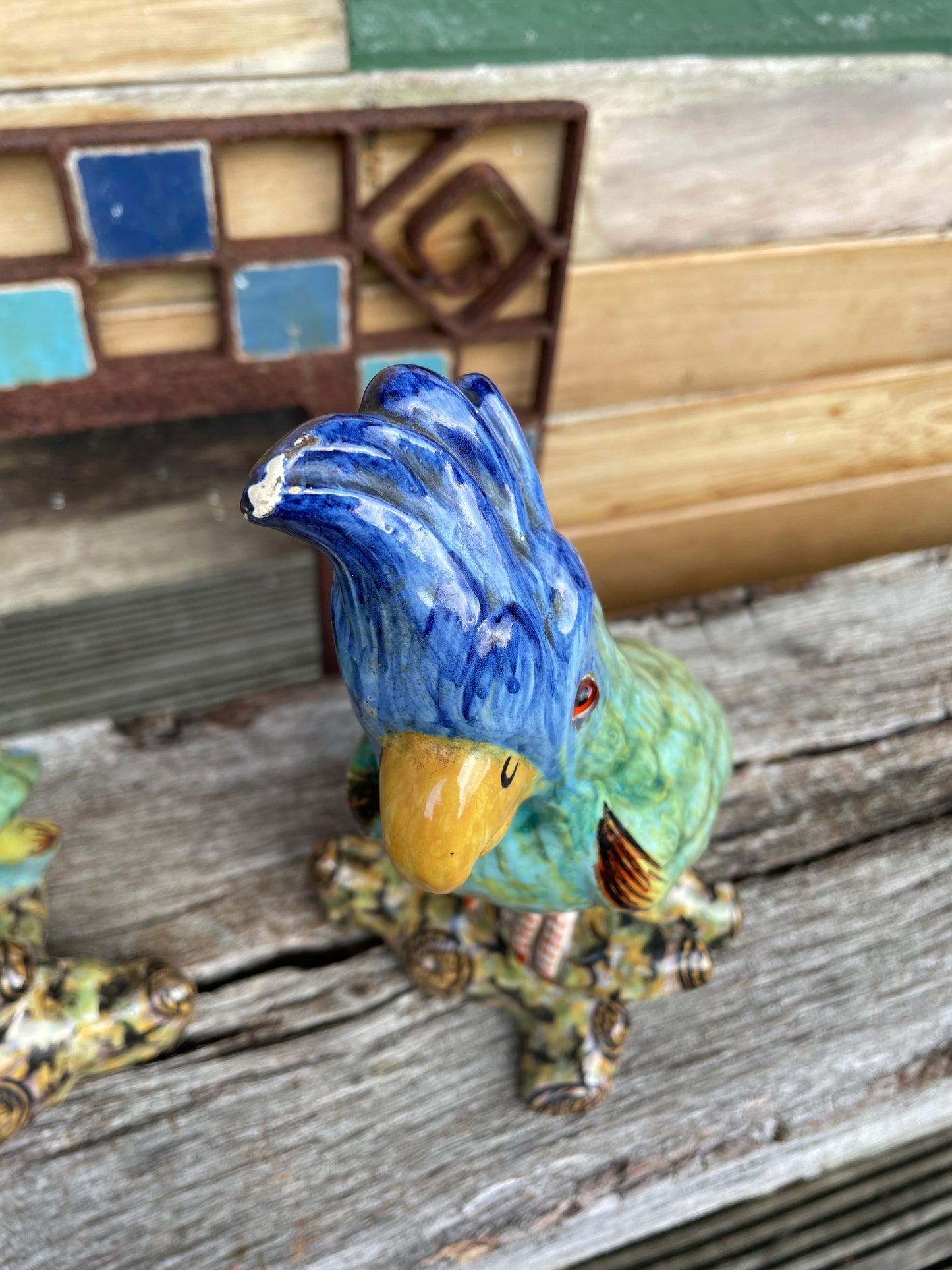Pair of antique continental faience signed ceramic parakeets 26cm tall