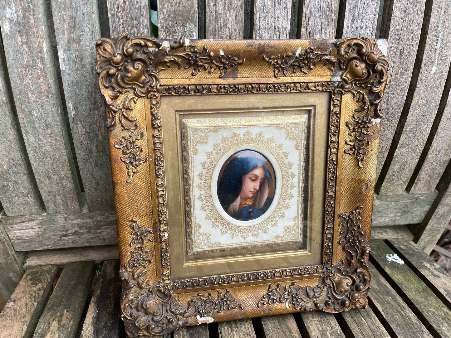 Antique watercolour miniature on ceramic cushion frame surround mounted in a giltwood and gesso decorated frame