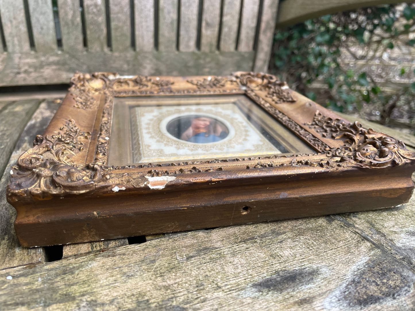 Antique watercolour miniature on ceramic cushion frame surround mounted in a giltwood and gesso decorated frame