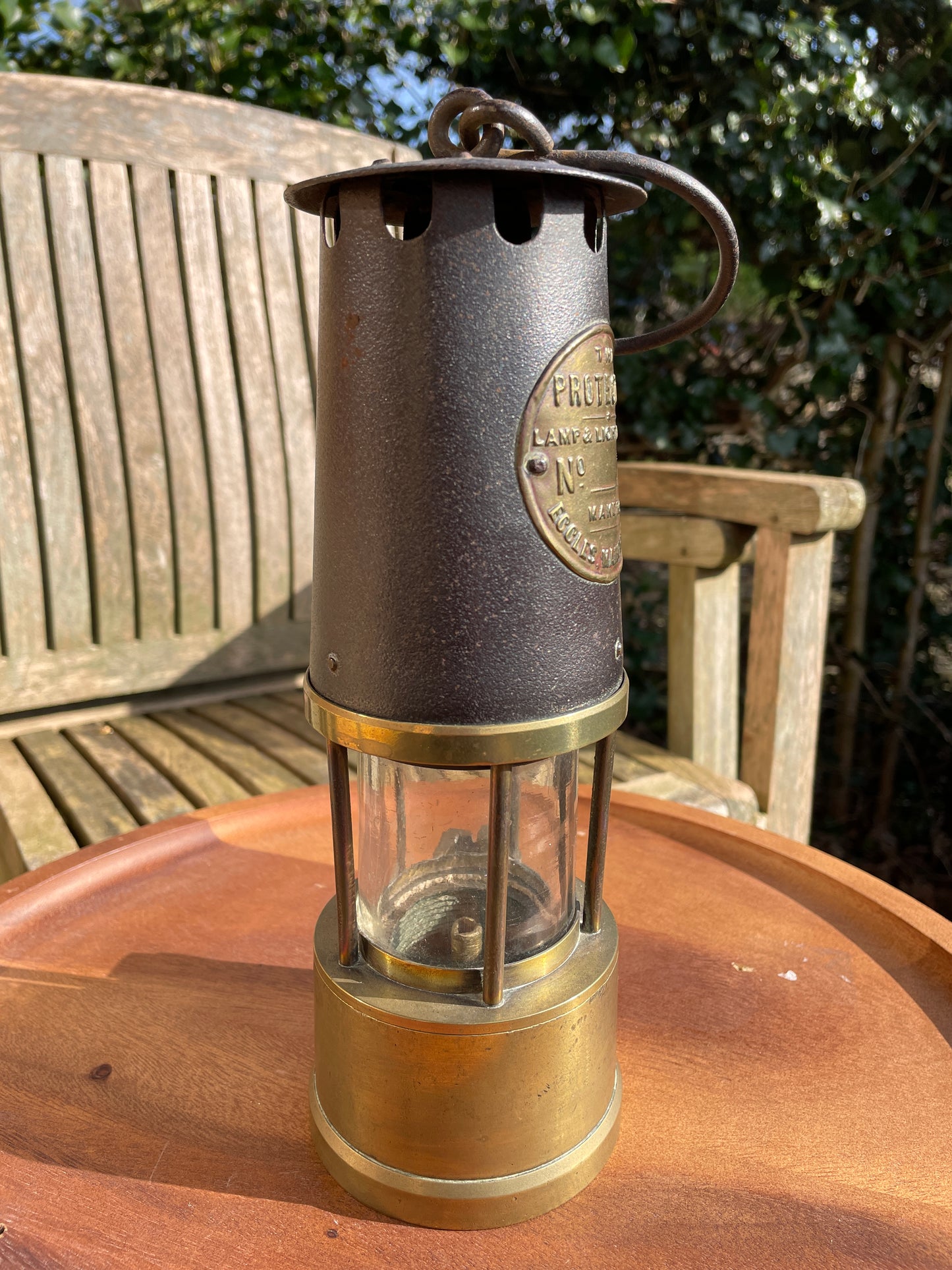 Antique brass miners lamp called The Protector lamp and lighting Co of Eccles Manchester