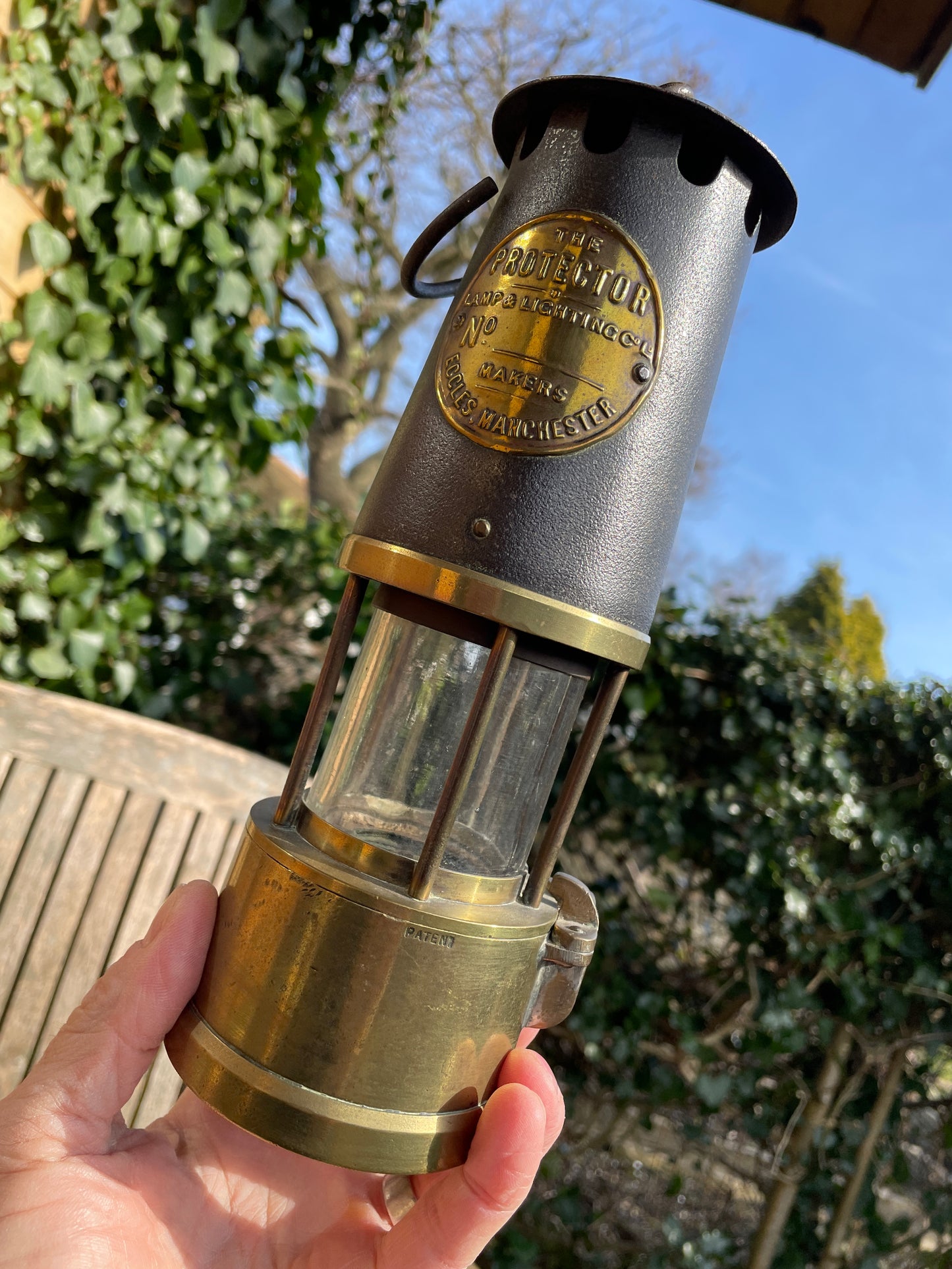 Antique brass miners lamp called The Protector lamp and lighting Co of Eccles Manchester