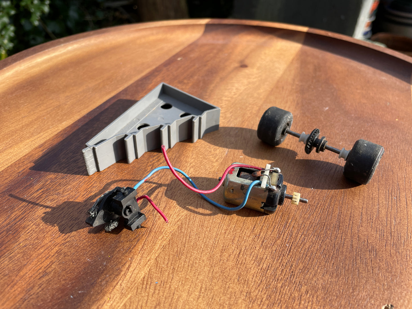 Original 70's Scalextric spares rear axil, motor and contact bushes, banked corner prop