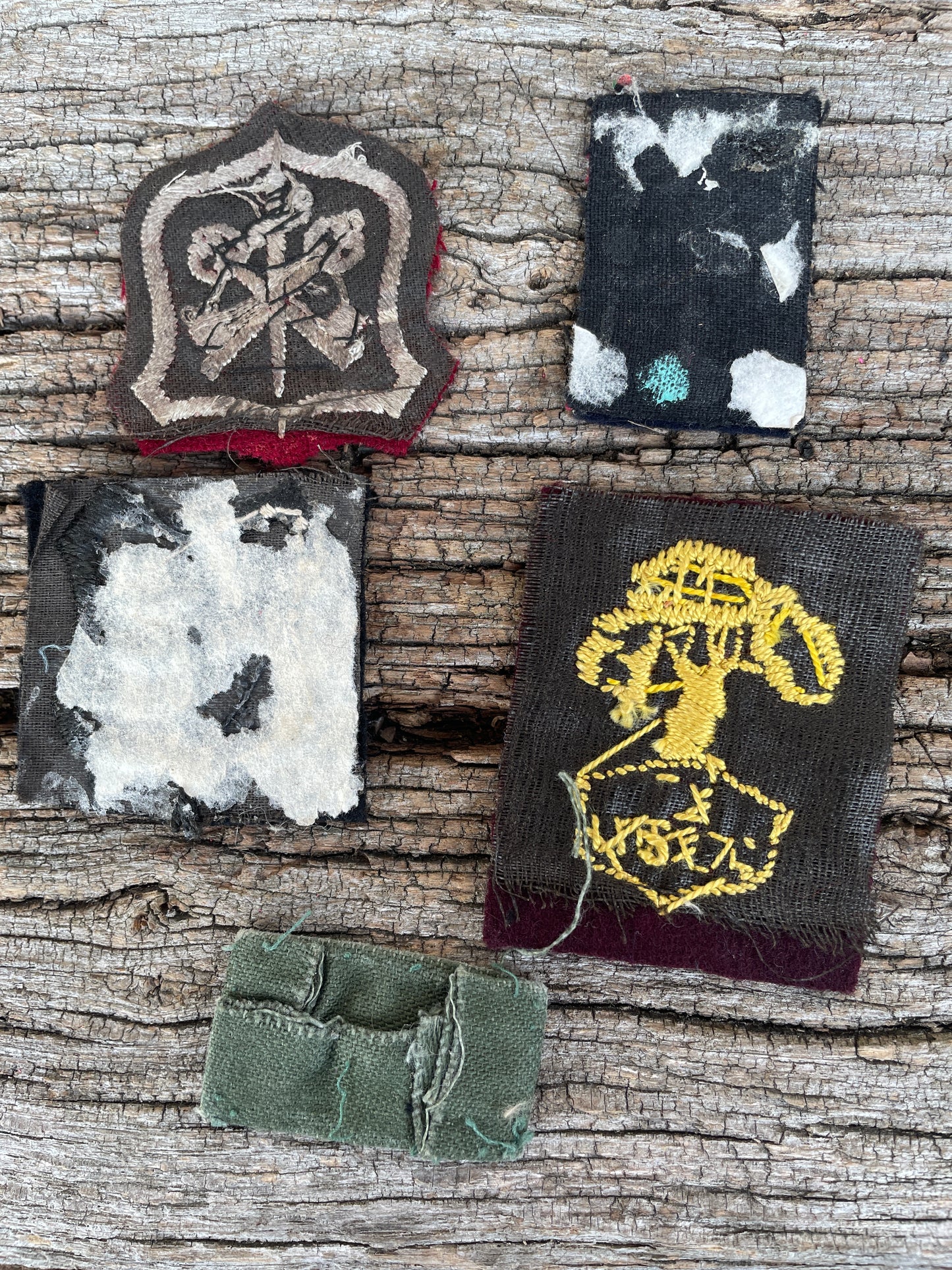 Collection of fabric military patches and badges including US and British examples