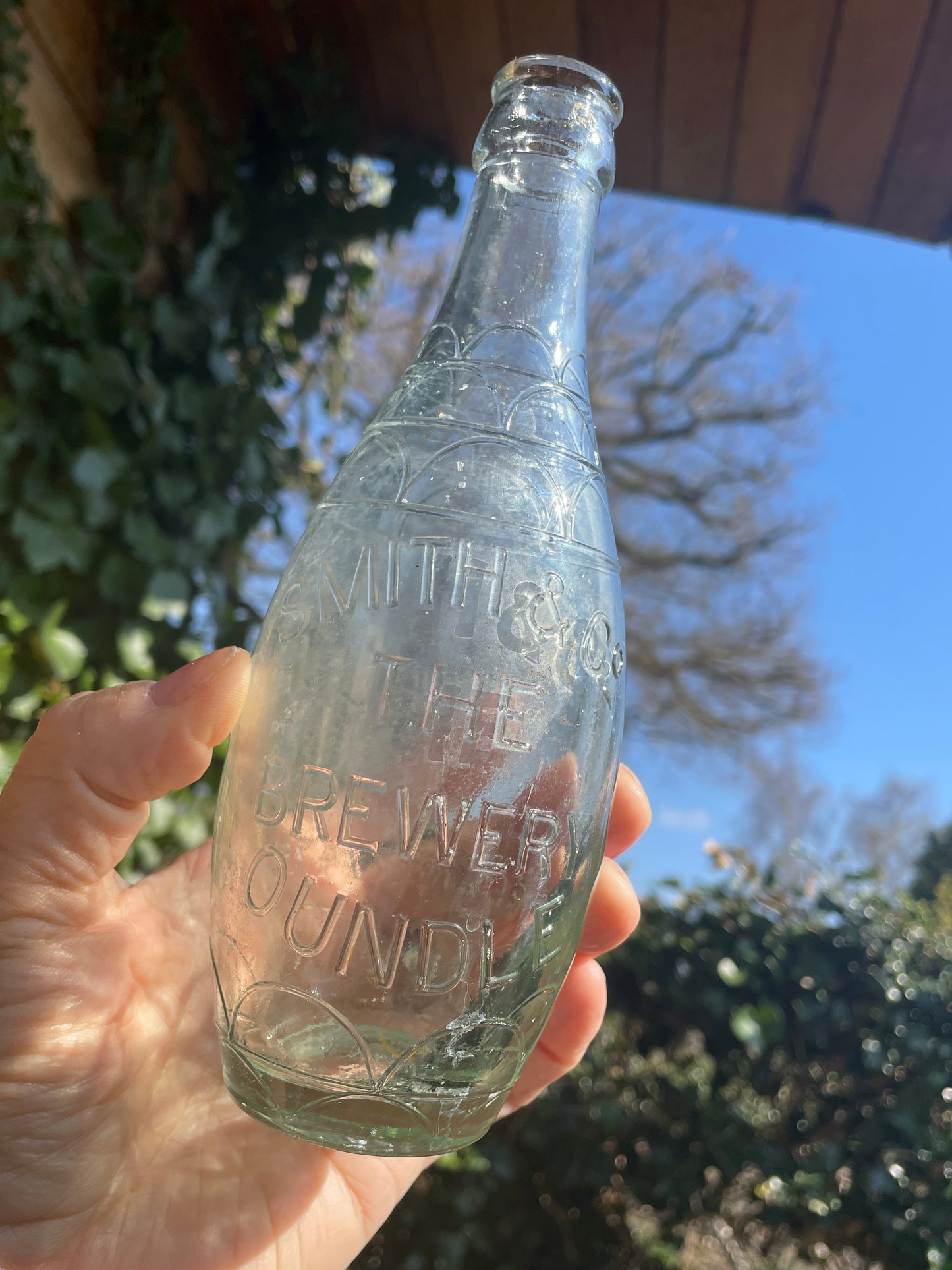Original decorative Smith and Co. The Brewery Oundle torpedo shaped clear glass bottle 1938