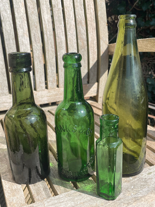 Four antique and vintage green glass bottles