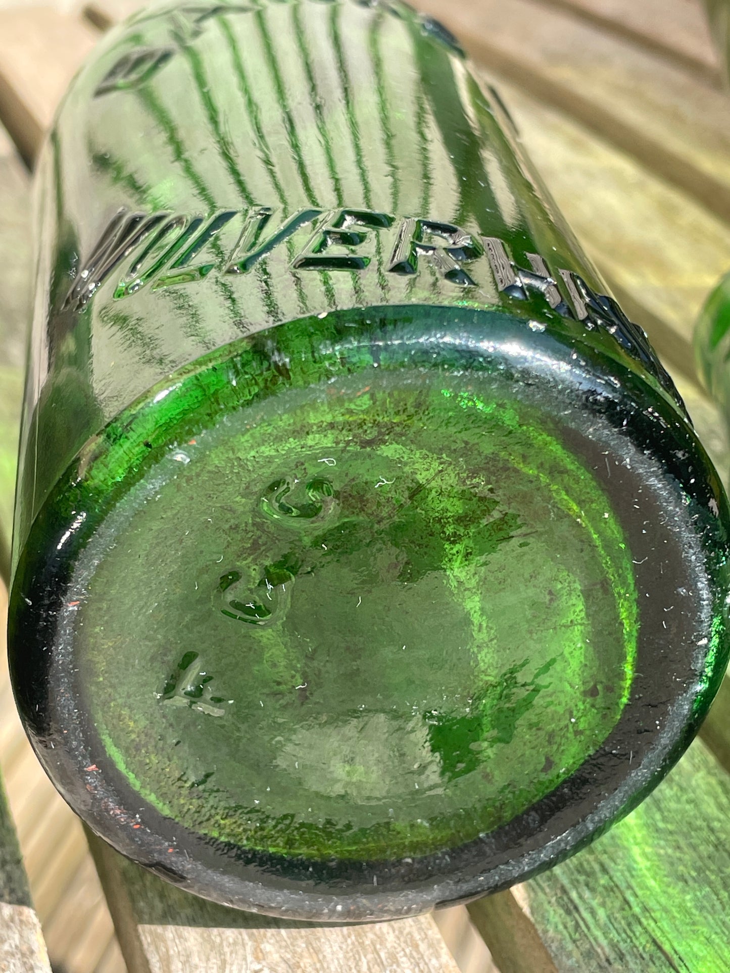 Four antique and vintage green glass bottles