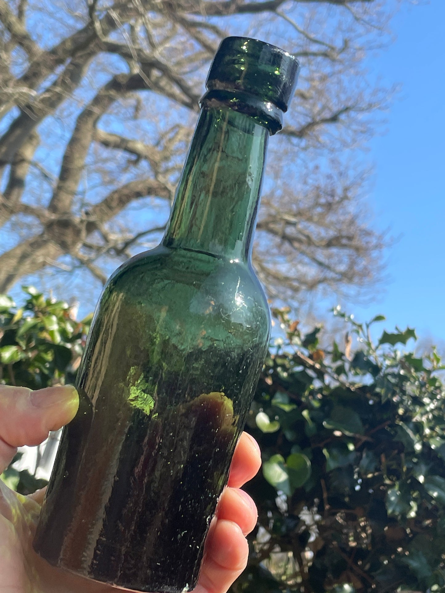 Four antique and vintage green glass bottles