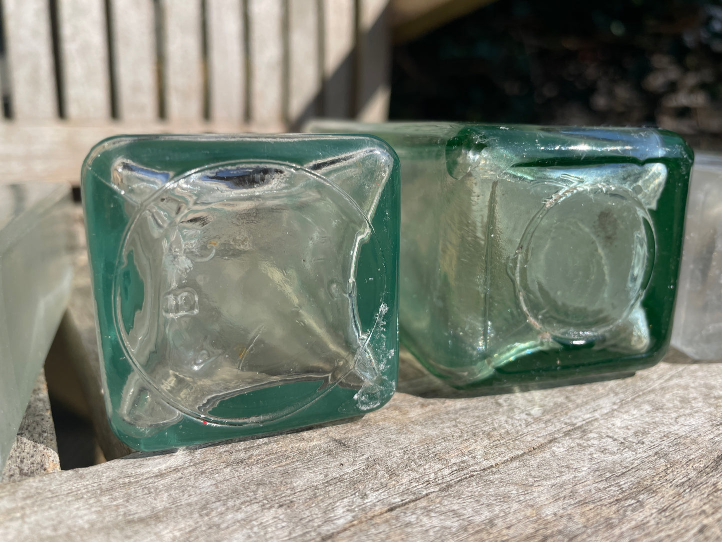 Six antique and vintage clear glass square section bottles tallest 21.5cm