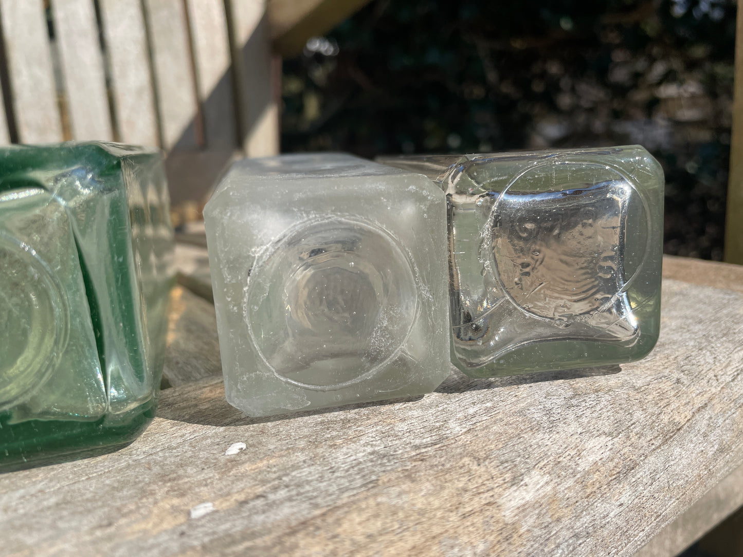 Six antique and vintage clear glass square section bottles tallest 21.5cm