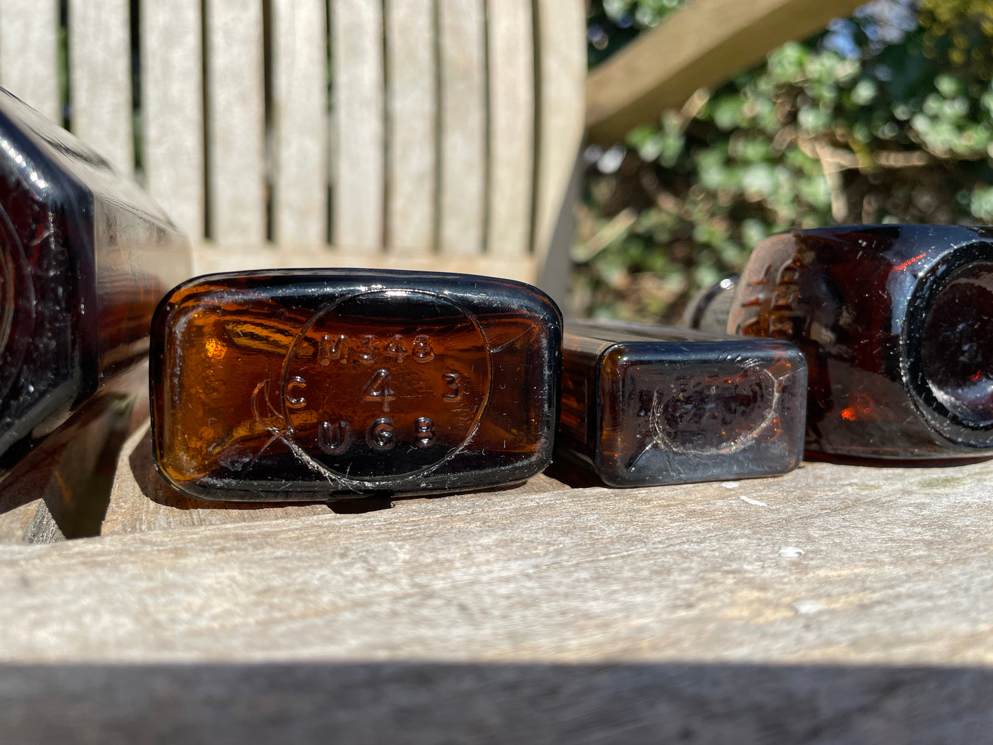 Five Antique and vintage brown glass bottles incl. Milton 4 and 5 and two ribbed Examples