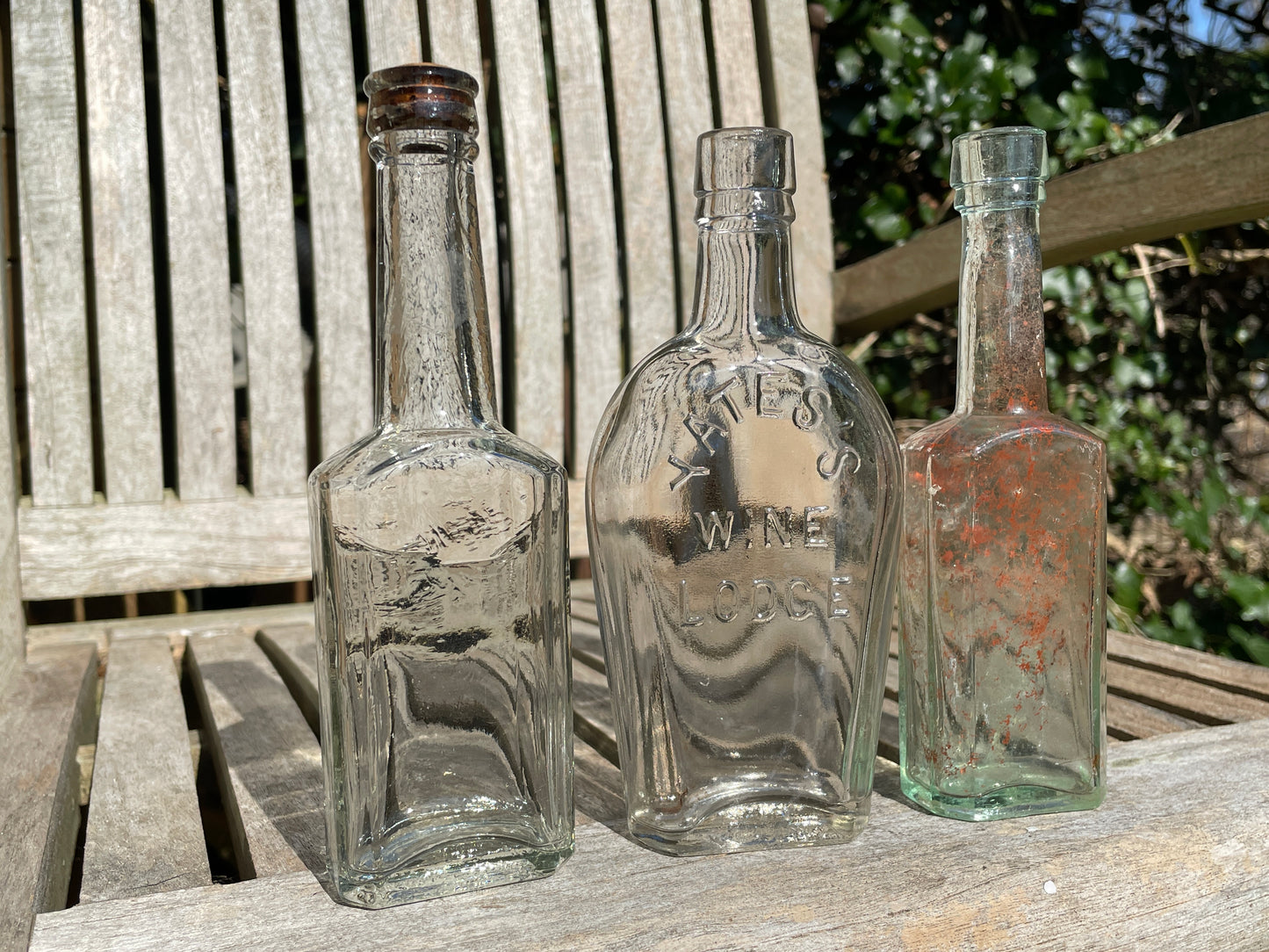 Yates's Wine Lodge and two other long necked antique bottles