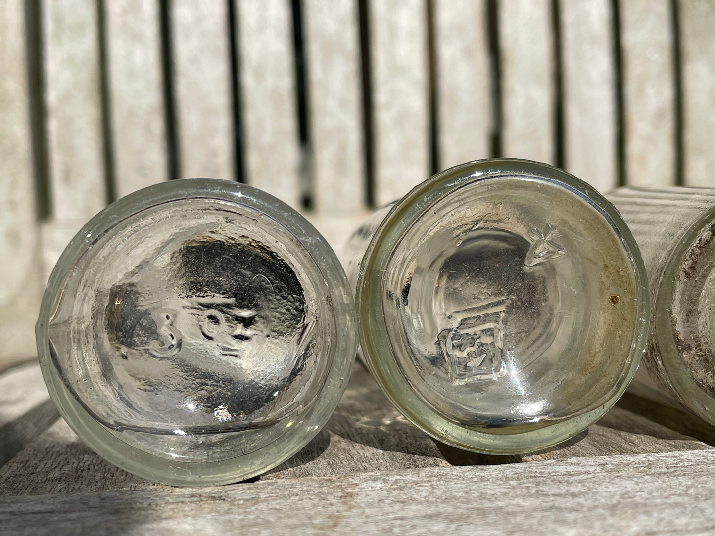 Four clear old glass medicine bottles tallest 11.5cm