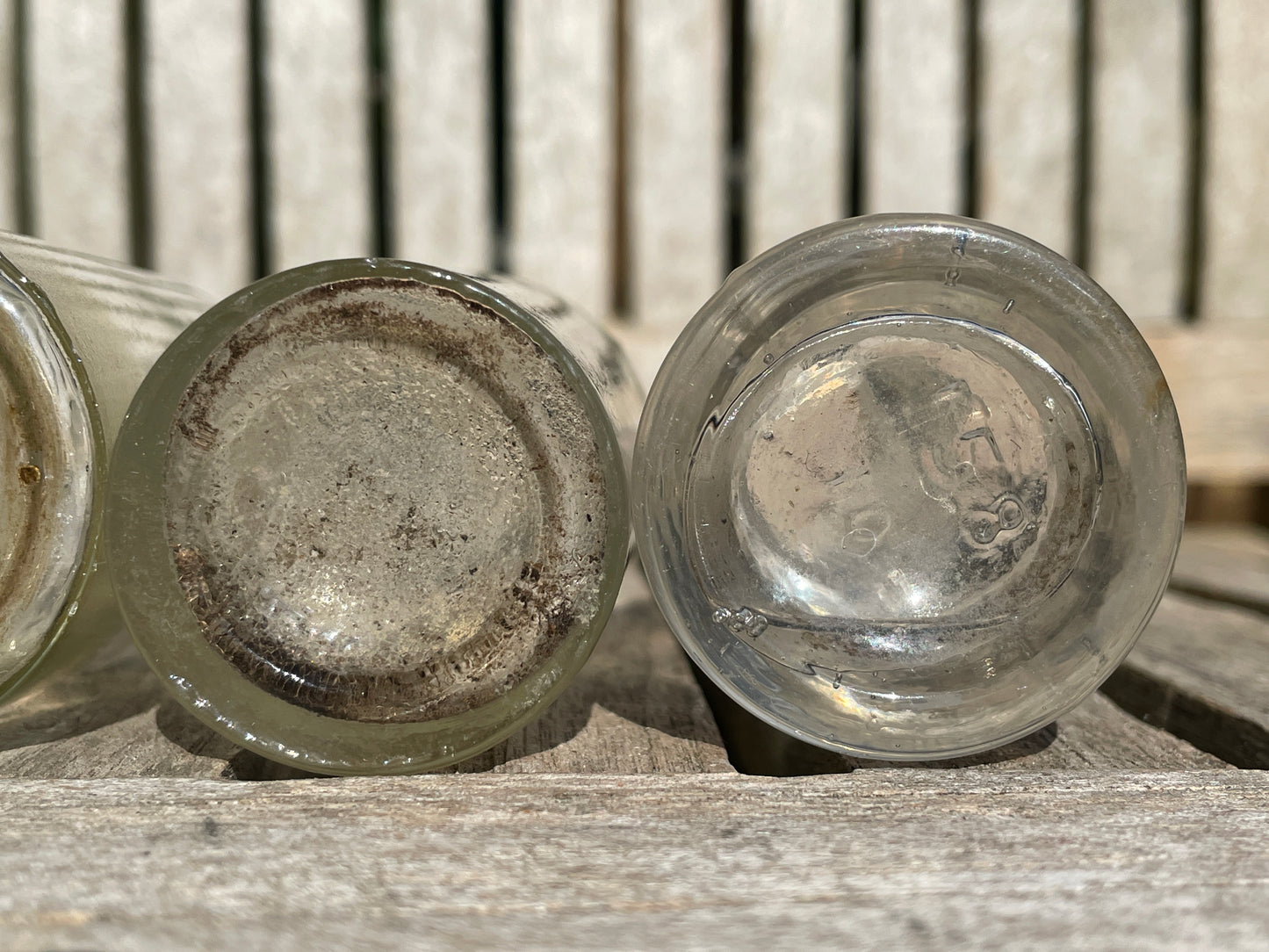 Four clear old glass medicine bottles tallest 11.5cm