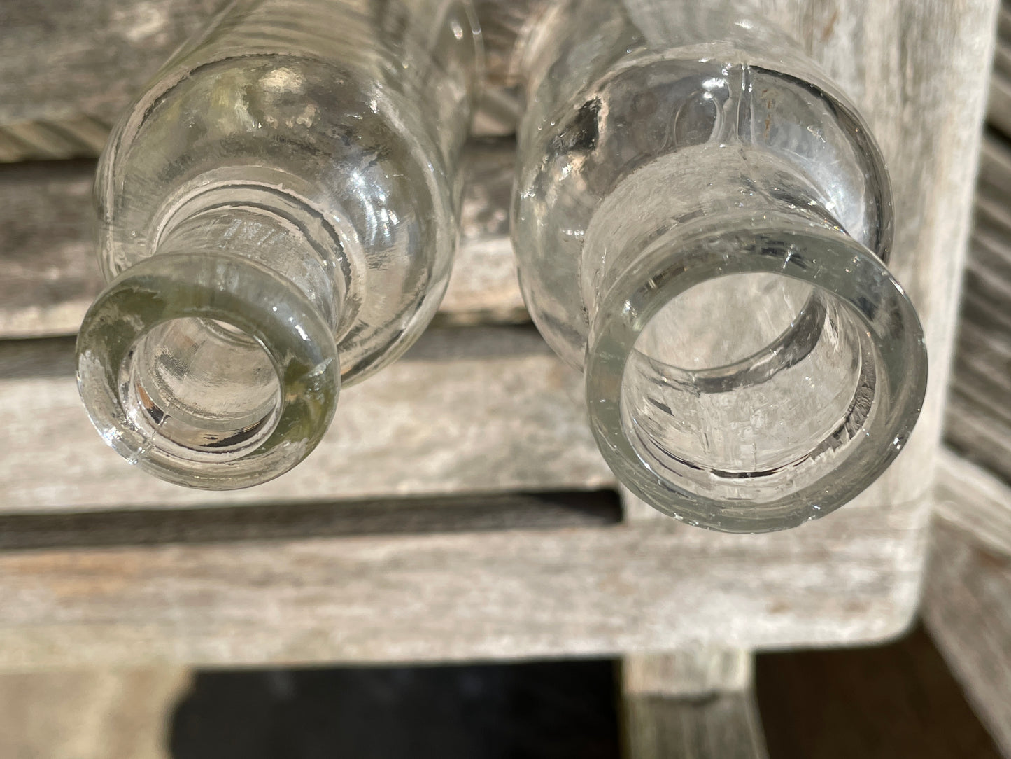 Four clear old glass medicine bottles tallest 11.5cm
