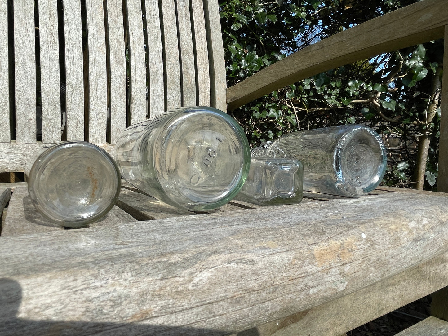 Four vintage clear glass bottles Tallest 19cm