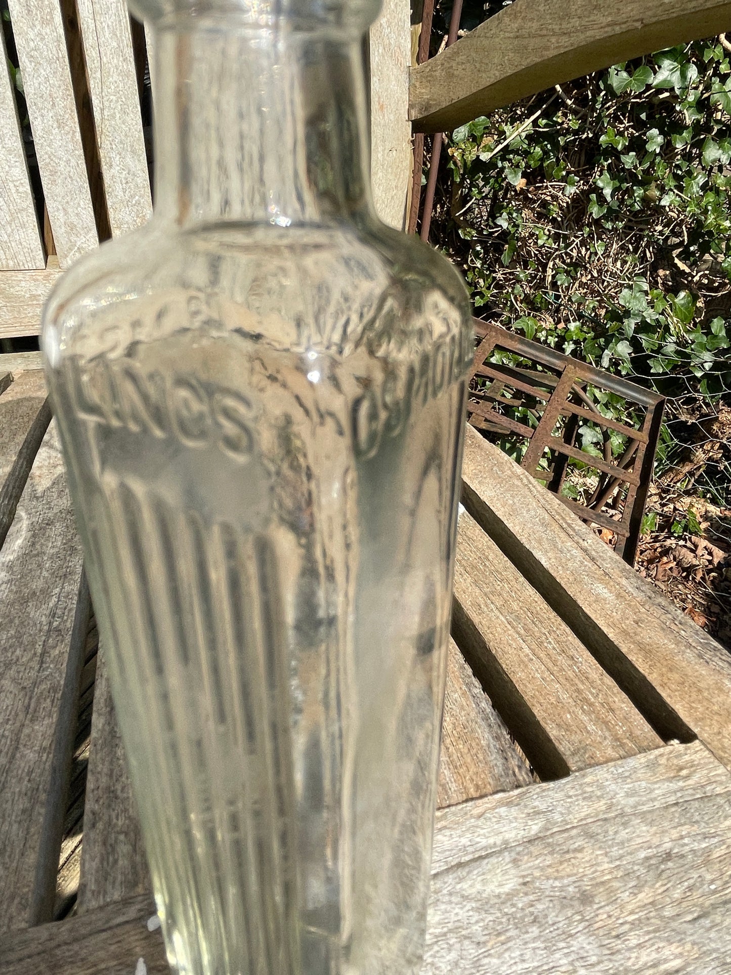 Four vintage clear glass bottles Tallest 19cm