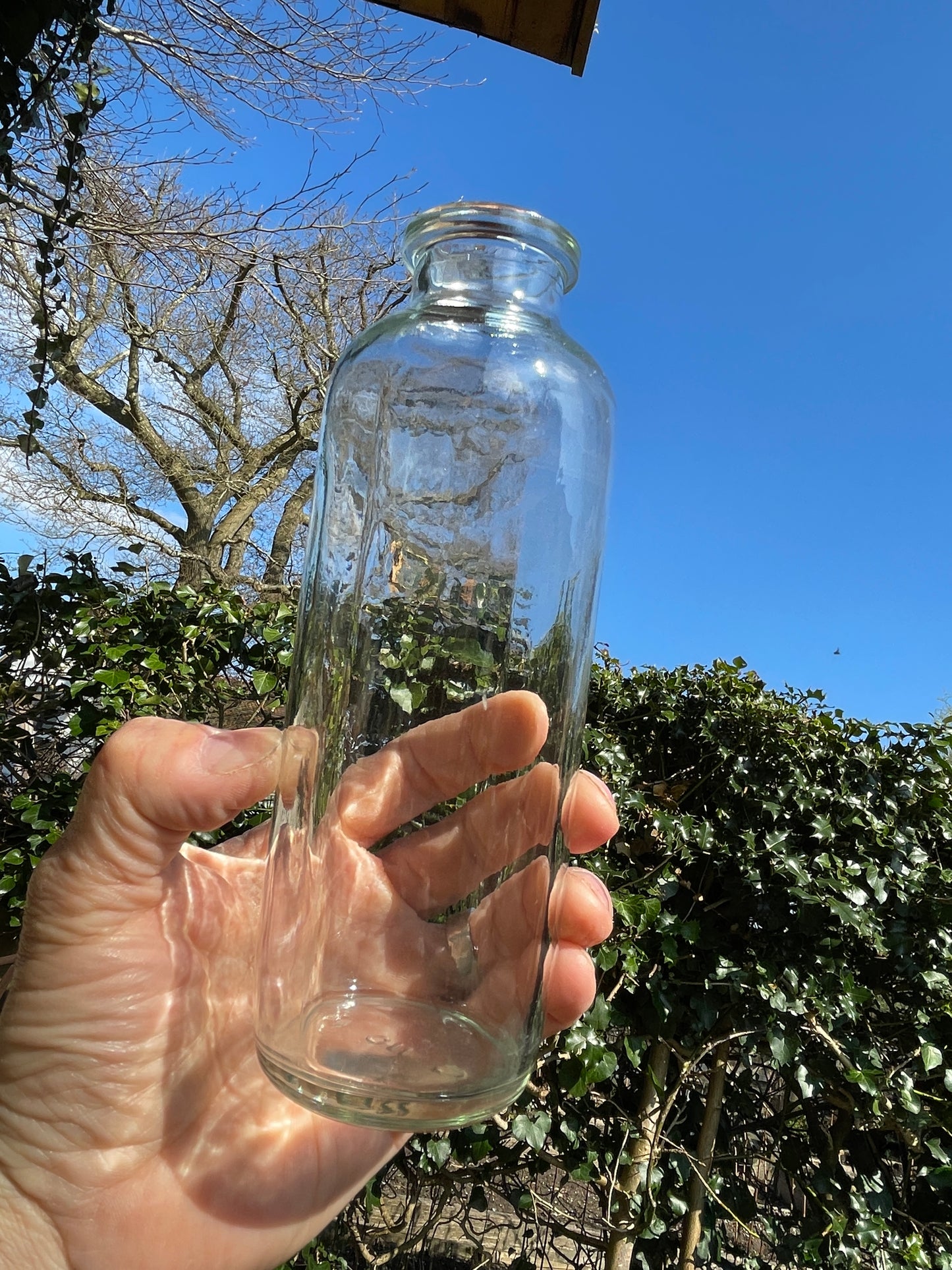 Four vintage clear glass bottles Tallest 19cm