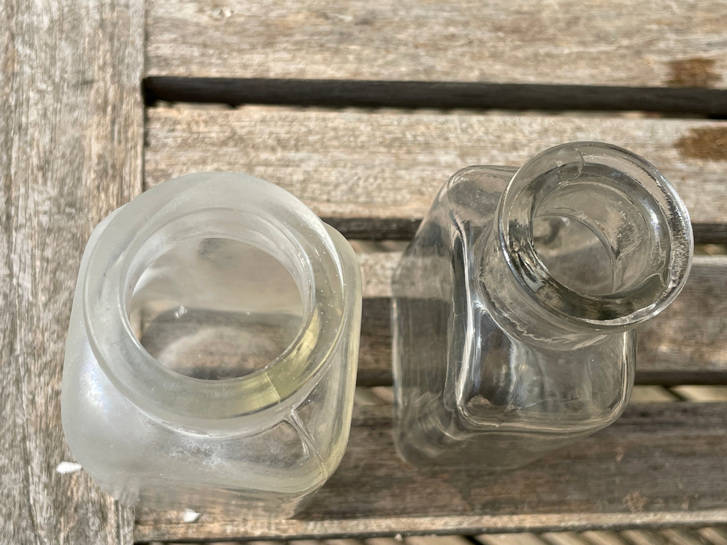 Four clear glass vintage bottles tallest 13.5cm one marked Furniture cream Stephenson Brothers