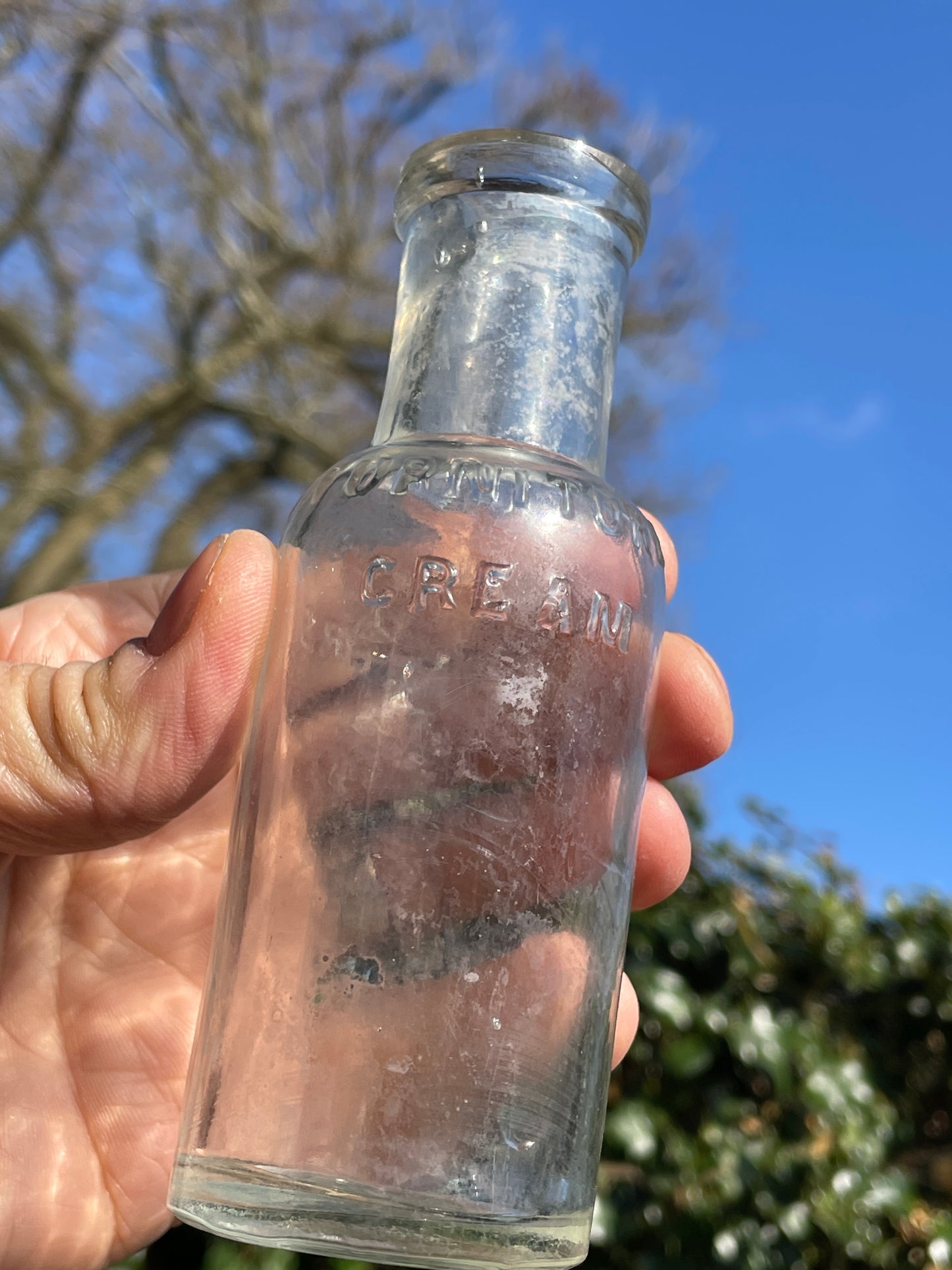 Four clear glass vintage bottles tallest 13.5cm one marked Furniture cream Stephenson Brothers