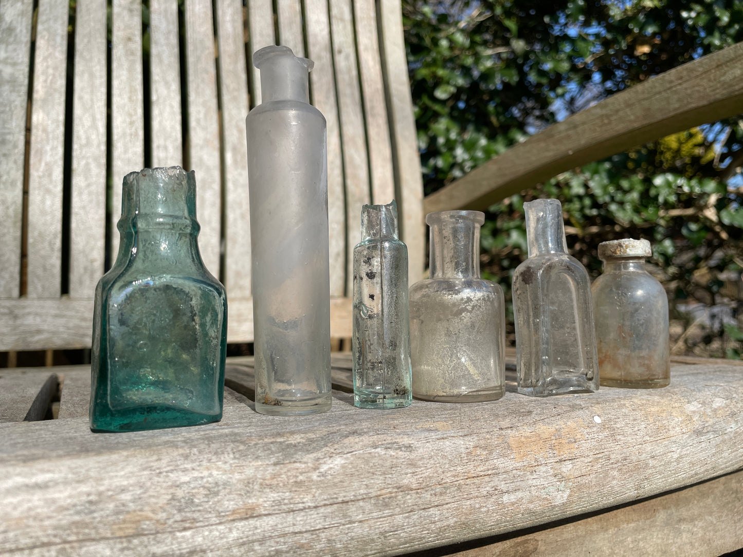 six  19th century glass bottles including Liquid gum Wolverhampton Reade Brothers and American examples