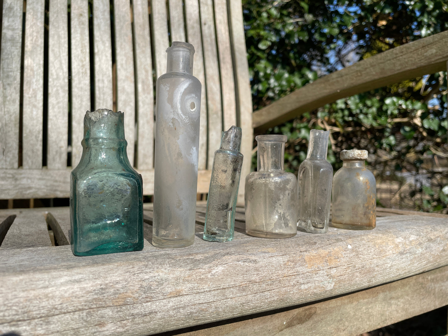 six  19th century glass bottles including Liquid gum Wolverhampton Reade Brothers and American examples
