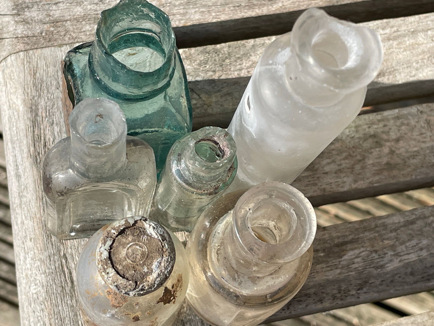 six  19th century glass bottles including Liquid gum Wolverhampton Reade Brothers and American examples