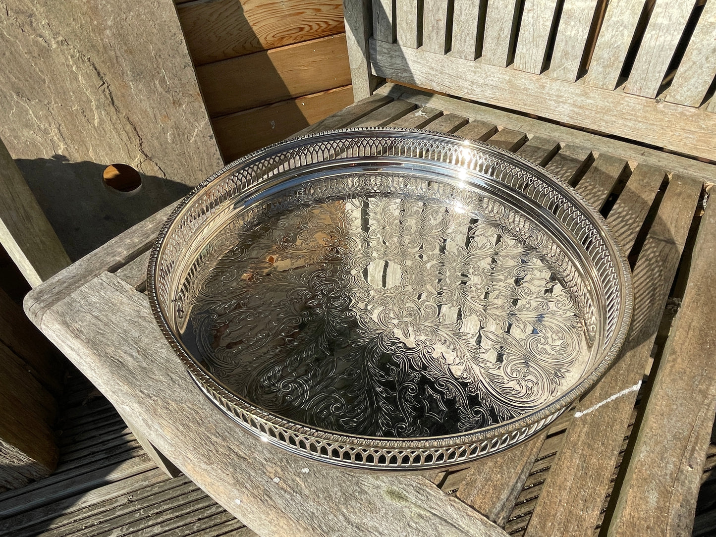 Early 20th century English silver plated galleried and ornately chased tray on three bun feet