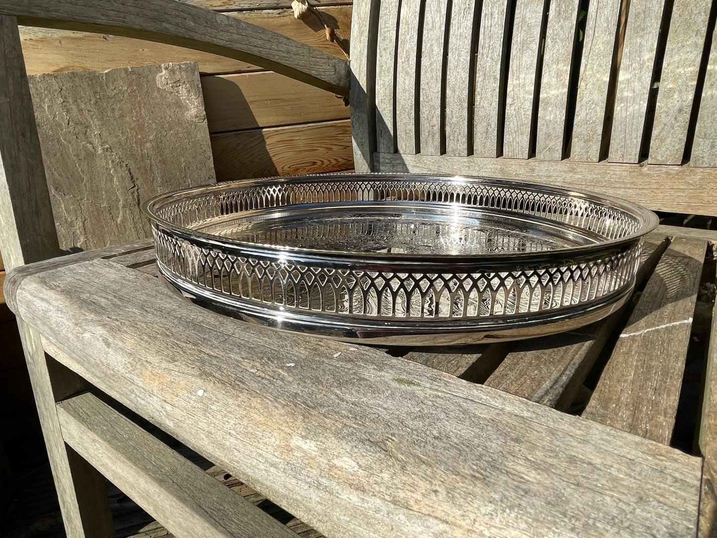 Early 20th century English silver plated galleried and ornately chased tray on three bun feet
