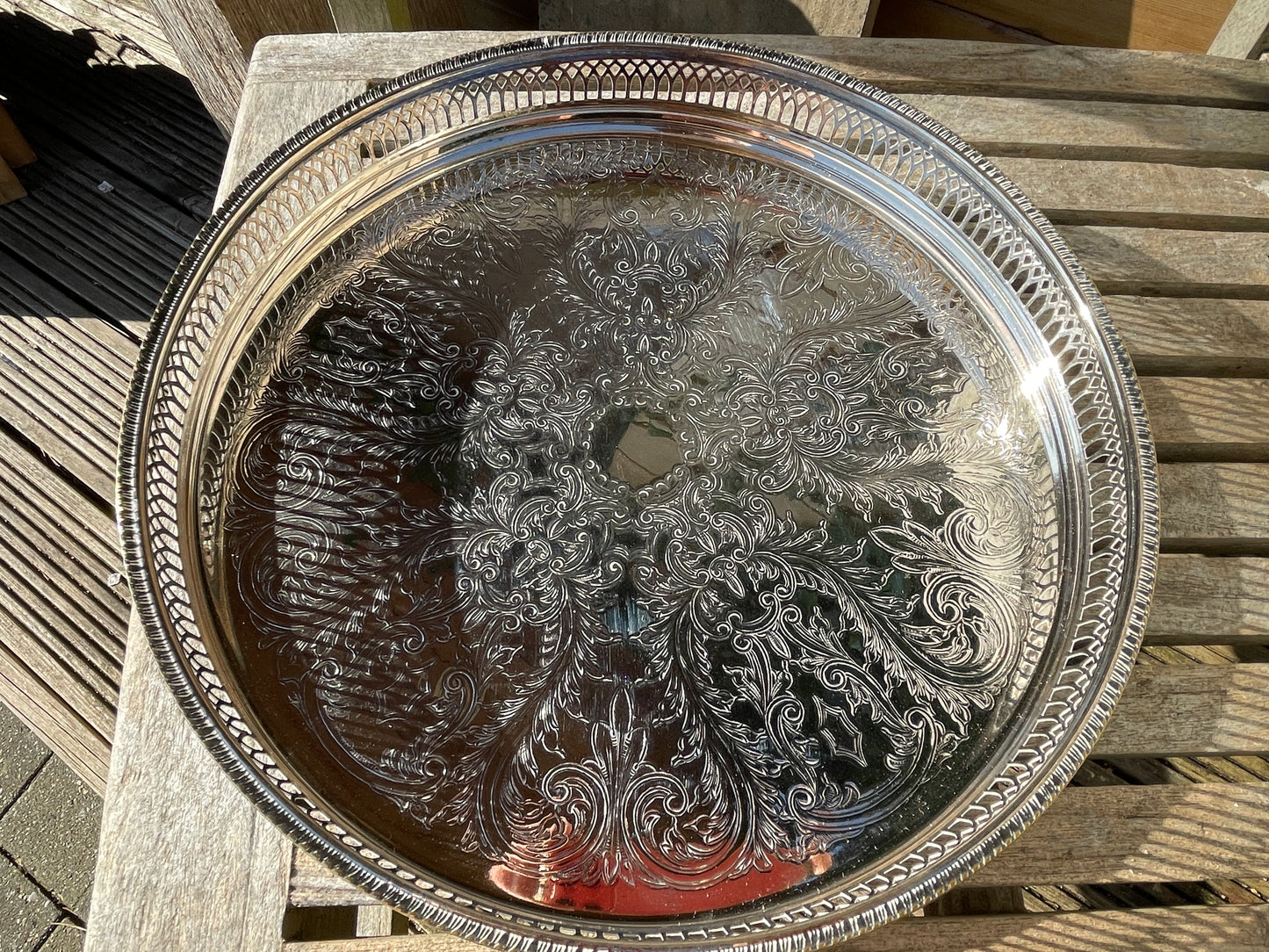 Early 20th century English silver plated galleried and ornately chased tray on three bun feet