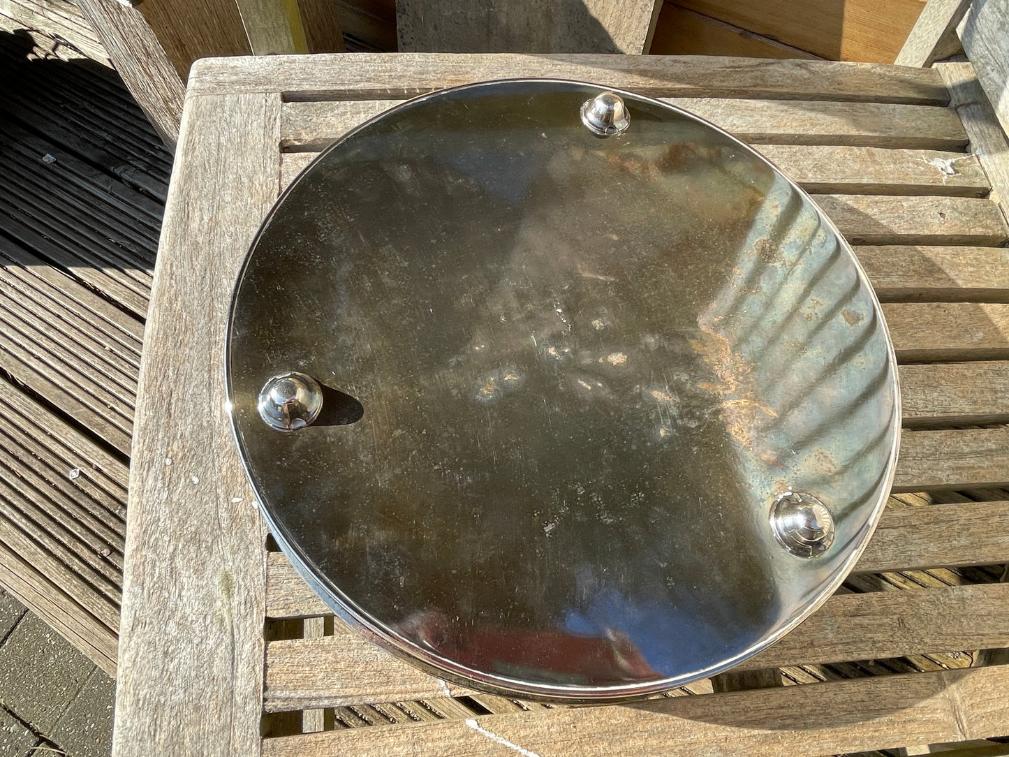 Early 20th century English silver plated galleried and ornately chased tray on three bun feet