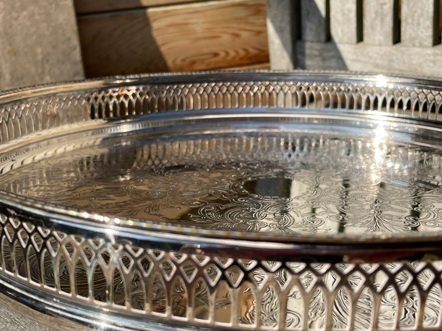 Early 20th century English silver plated galleried and ornately chased tray on three bun feet