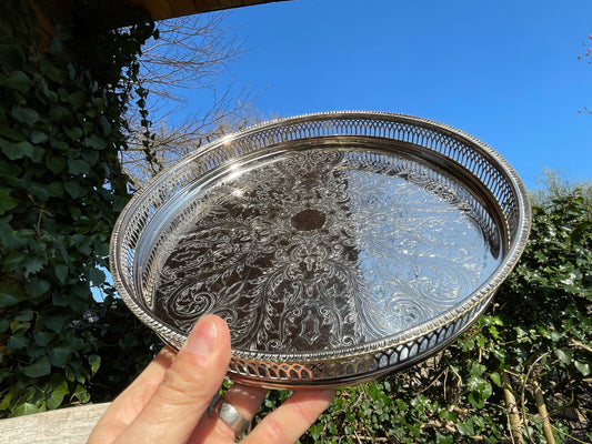 Early 20th century English silver plated galleried and ornately chased tray on three bun feet