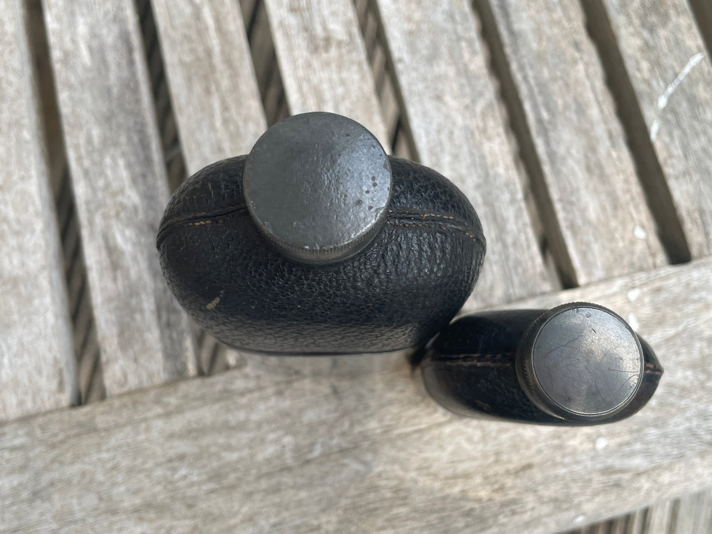 Pair of Vintage Leather & Metal Hip Flasks – Travel Companion Bottles with Removable Cups, Early to Mid 20th Century