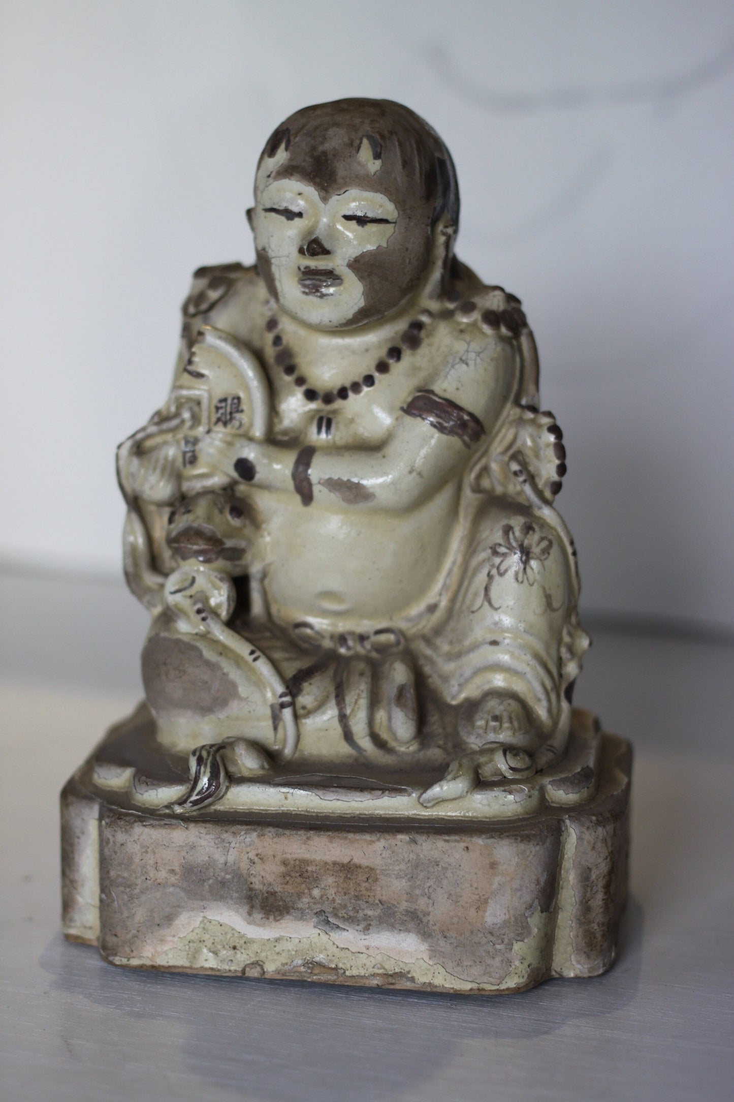 A Chinese Cizhou Seated Figure of Liu Hai, Possibly Ming Dynasty, 21cms high, Glaze Flaking