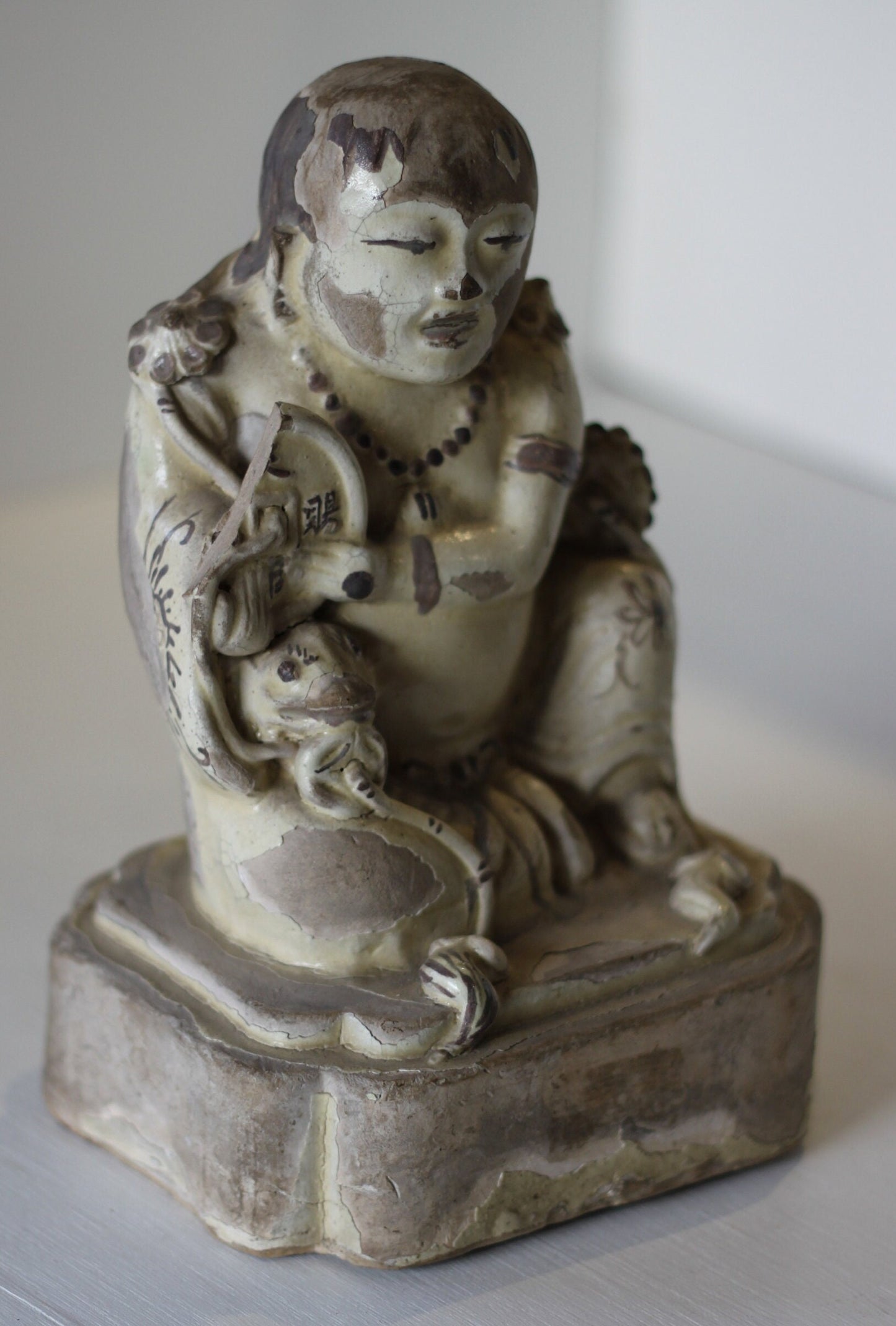A Chinese Cizhou Seated Figure of Liu Hai, Possibly Ming Dynasty, 21cms high, Glaze Flaking
