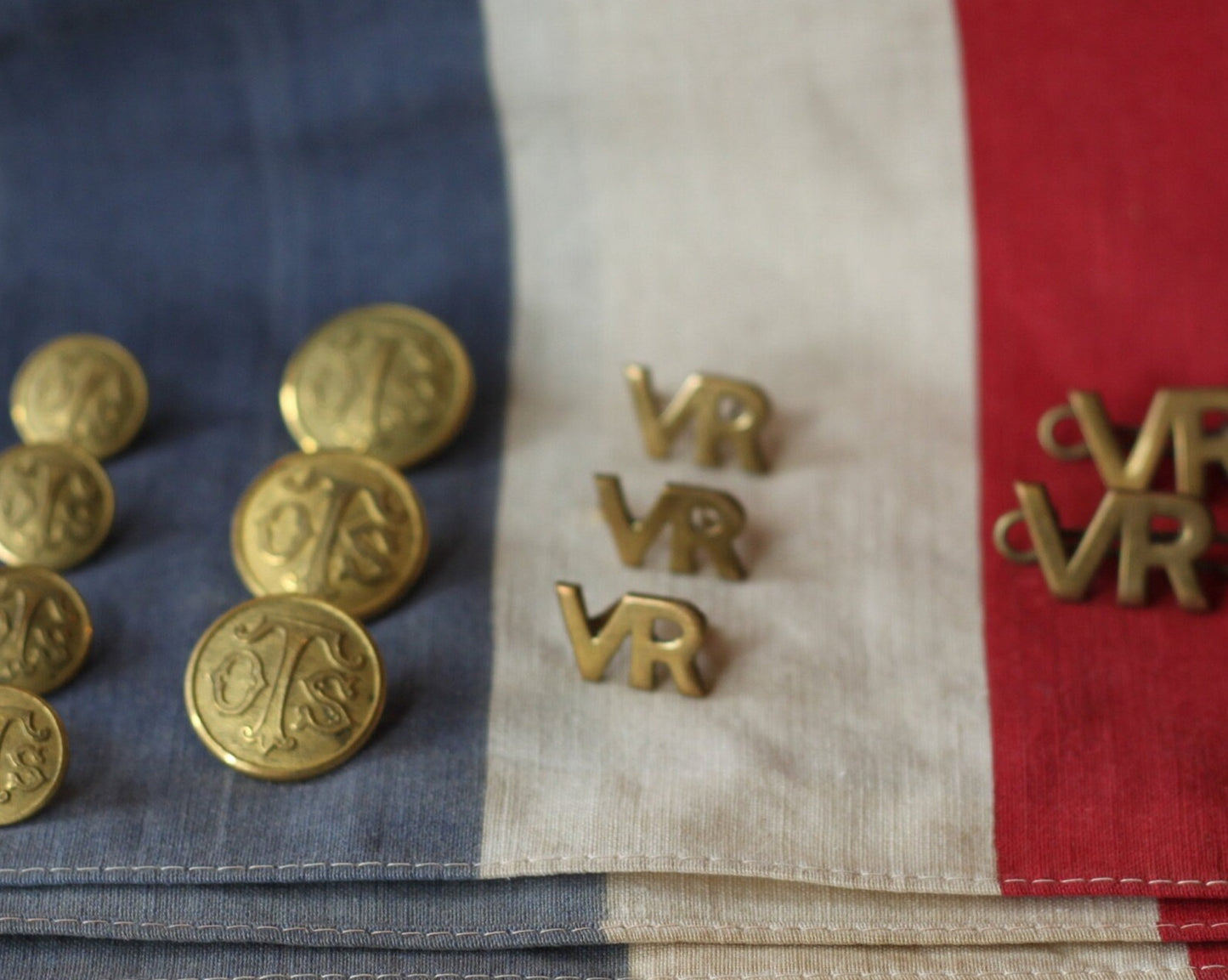 Five Volunteer Reserves Brass 'VR's' Title badges and Seven oTs Officer Training School Gilt Uniform Buttons by Firmin & Sons
