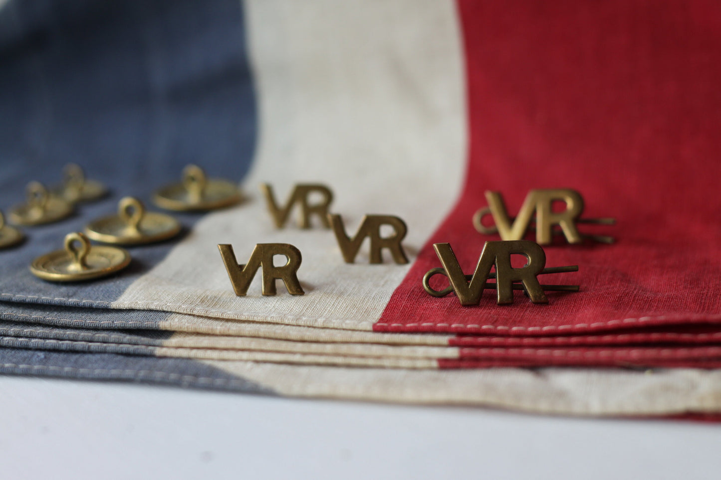 Five Volunteer Reserves Brass 'VR's' Title badges and Seven oTs Officer Training School Gilt Uniform Buttons by Firmin & Sons