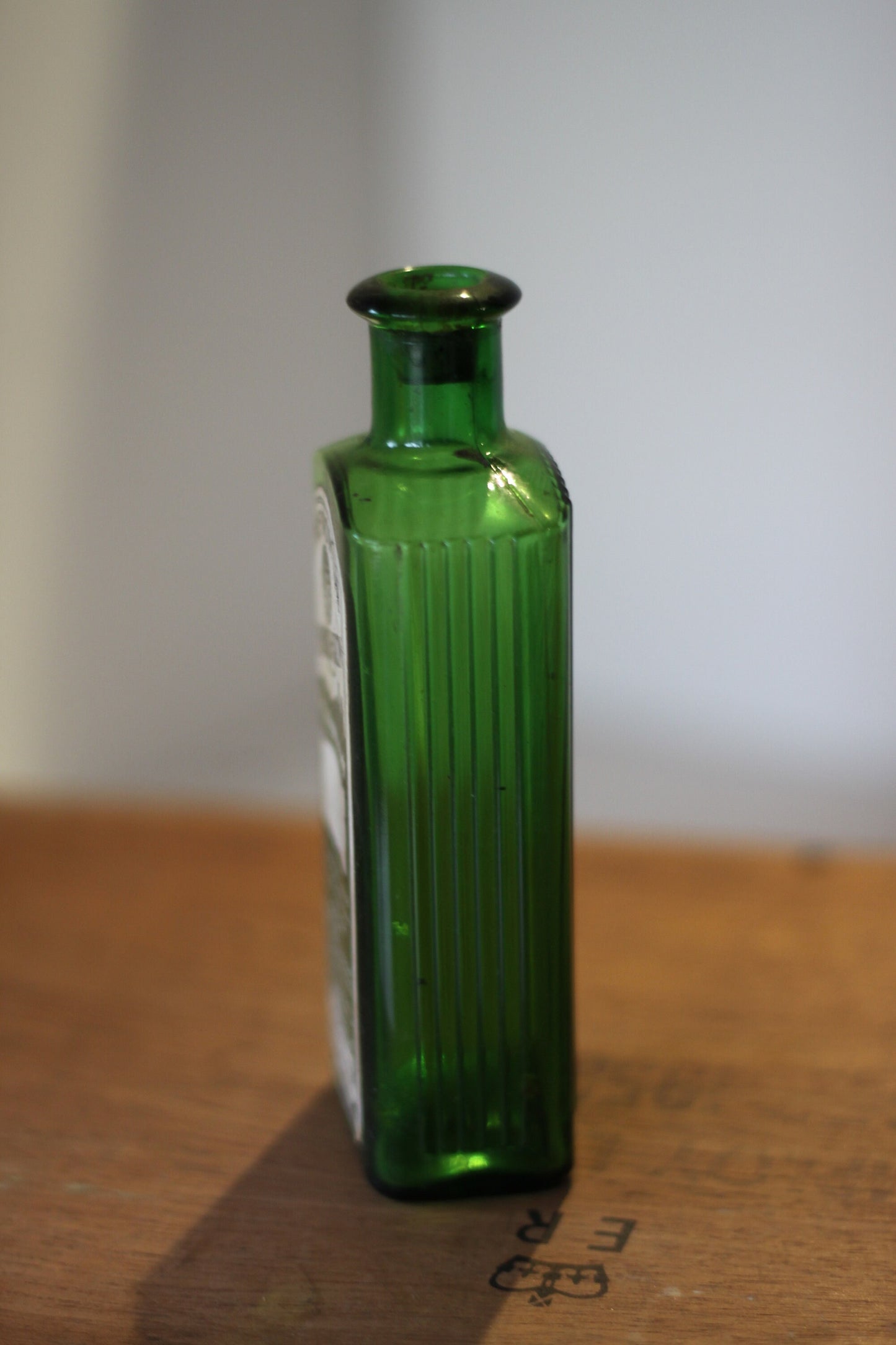 A Gorgeous Vintage Green Ribbed Bottle With its Original Label for 'The Worlds Embrocation" Excellent condition