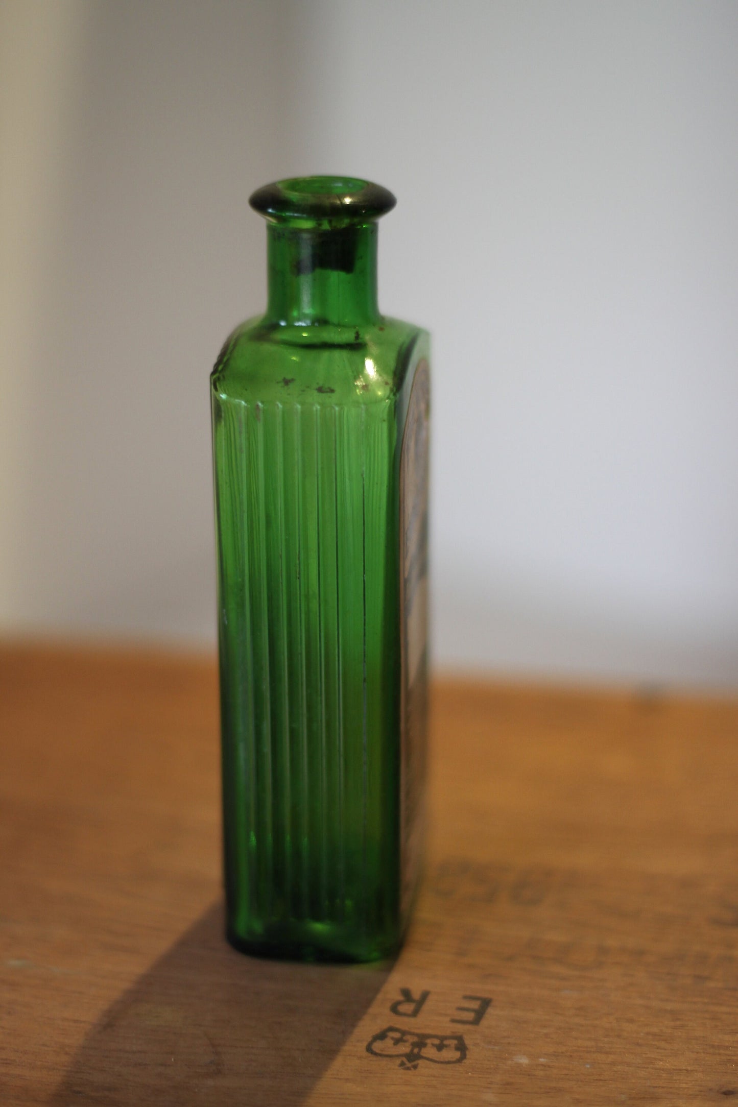 A Gorgeous Vintage Green Ribbed Bottle With its Original Label for 'The Worlds Embrocation" Excellent condition