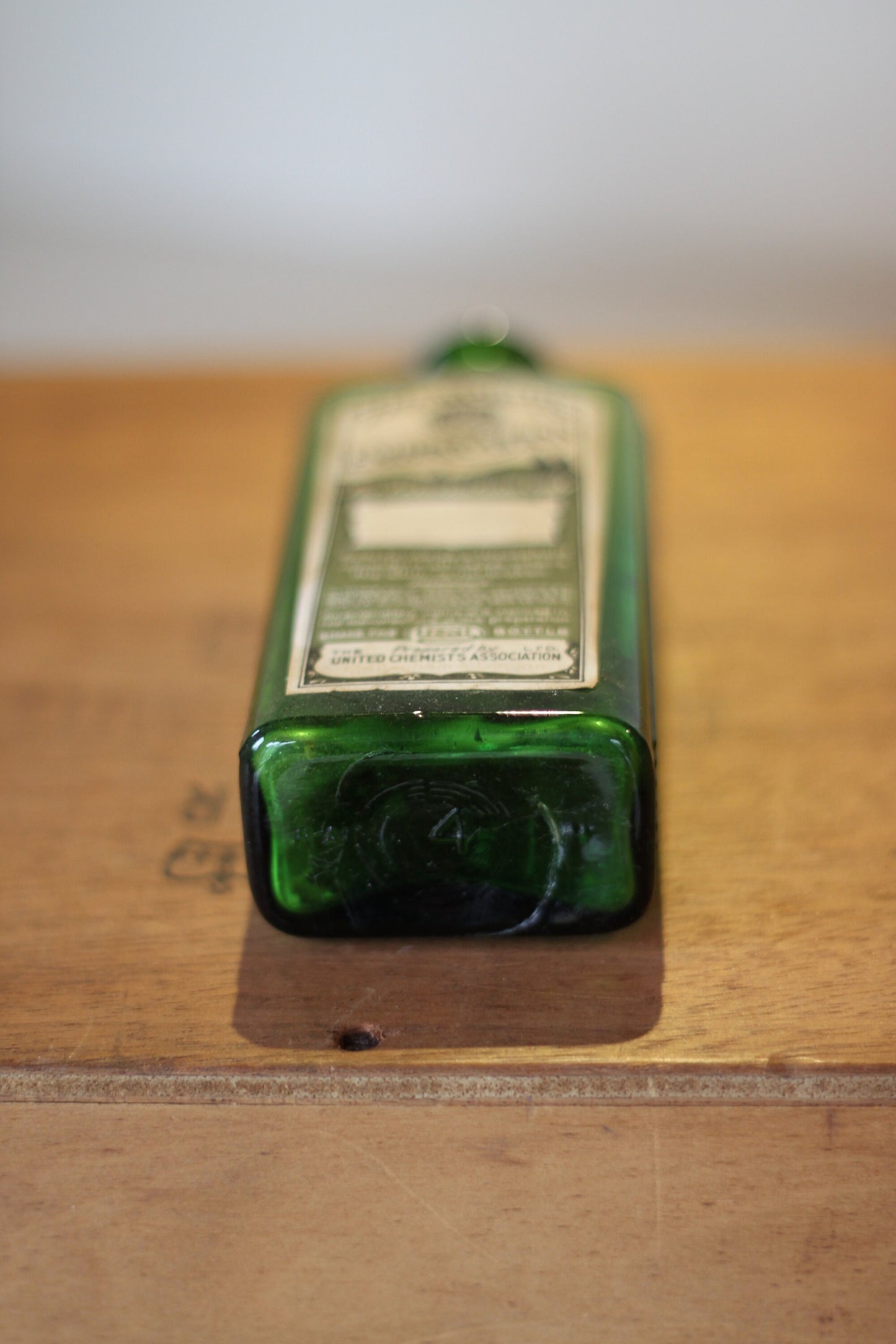 A Gorgeous Vintage Green Ribbed Bottle With its Original Label for 'The Worlds Embrocation" Excellent condition
