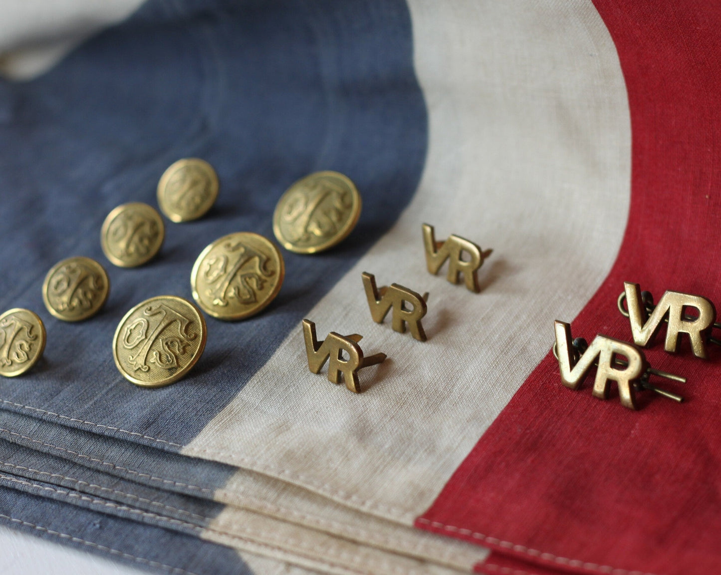 Five Volunteer Reserves Brass 'VR's' Title badges and Seven oTs Officer Training School Gilt Uniform Buttons by Firmin & Sons