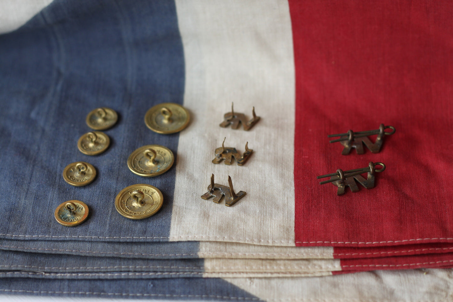 Five Volunteer Reserves Brass 'VR's' Title badges and Seven oTs Officer Training School Gilt Uniform Buttons by Firmin & Sons