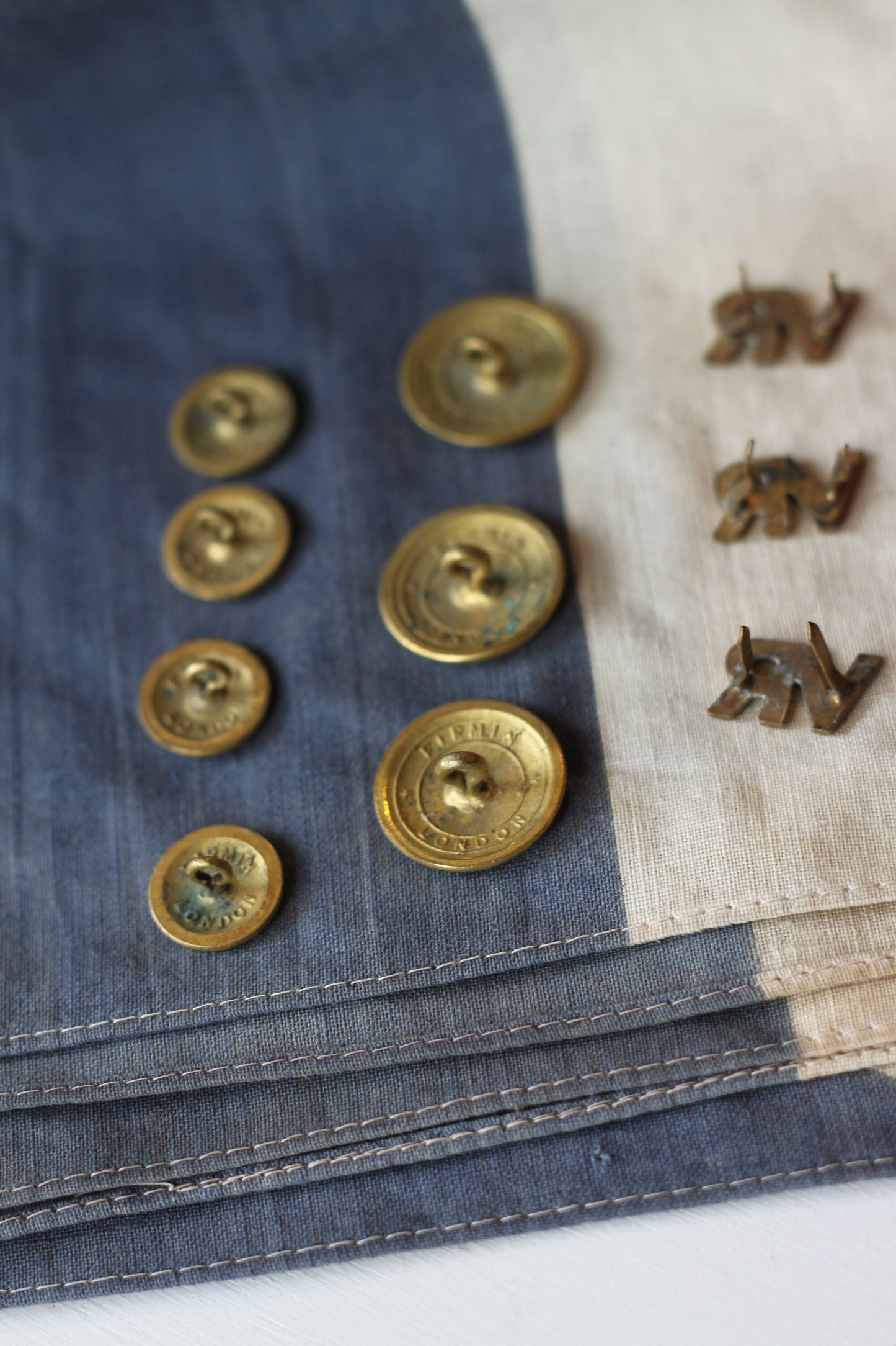 Five Volunteer Reserves Brass 'VR's' Title badges and Seven oTs Officer Training School Gilt Uniform Buttons by Firmin & Sons