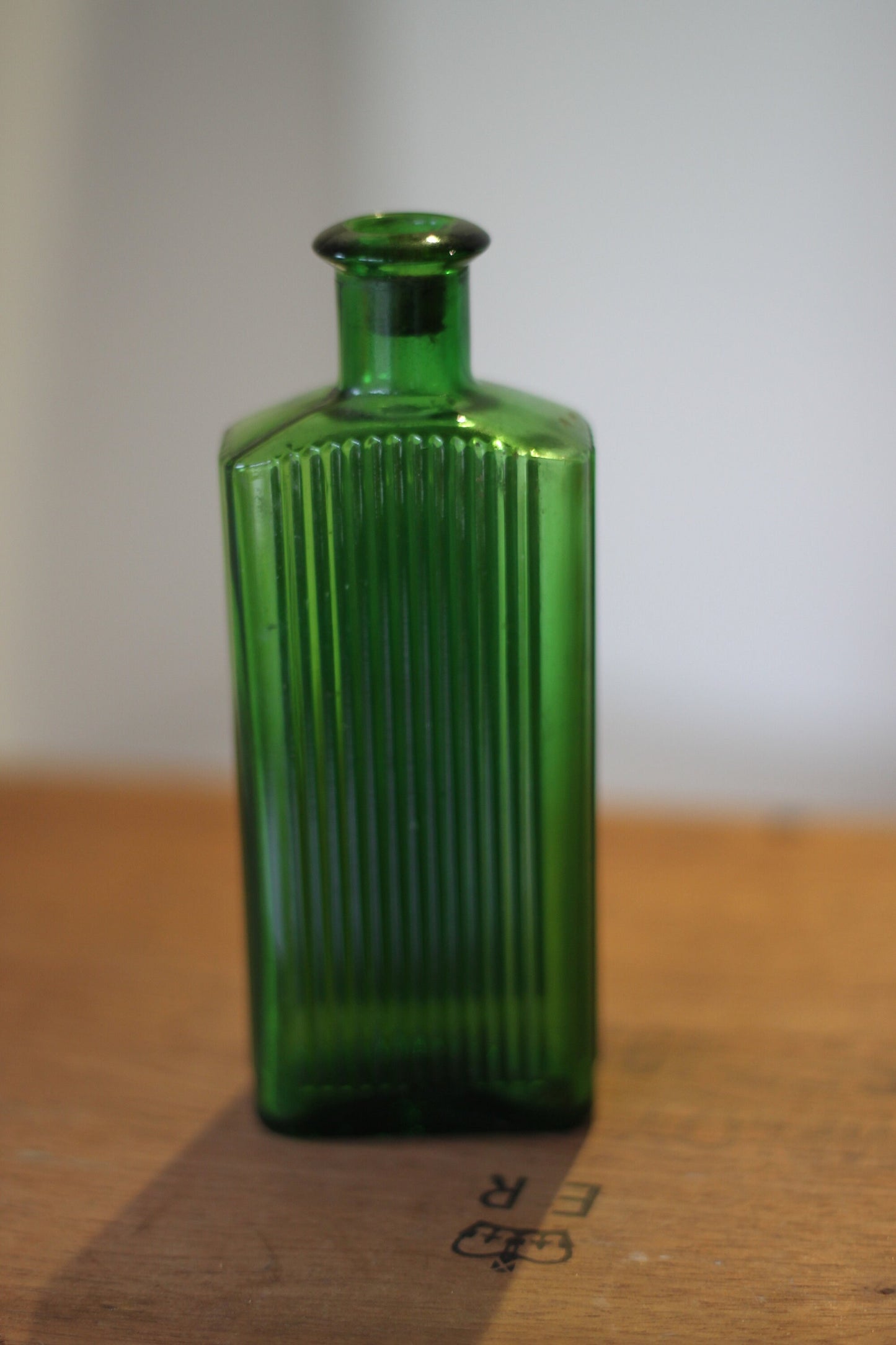 A Gorgeous Vintage Green Ribbed Bottle With its Original Label for 'The Worlds Embrocation" Excellent condition
