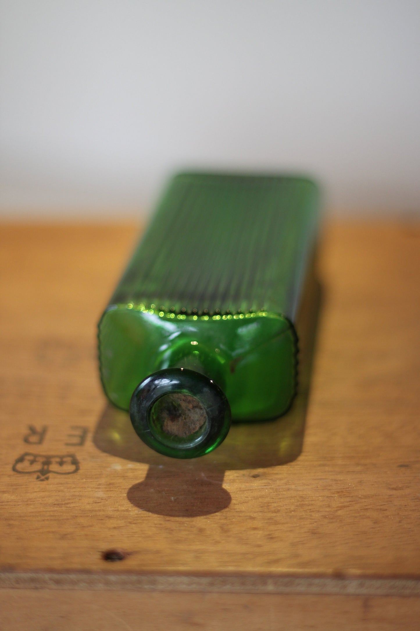 A Gorgeous Vintage Green Ribbed Bottle With its Original Label for 'The Worlds Embrocation" Excellent condition