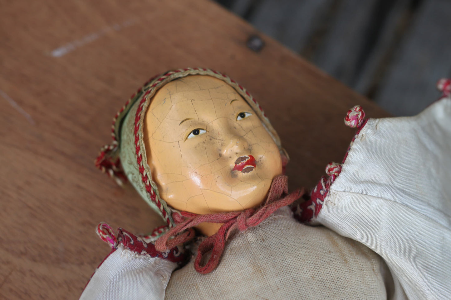 Vintage Chinese carved wood doll with amulet coin – 23cm straw-stuffed cloth body, painted face, cap & jacket c.1930s–50s
