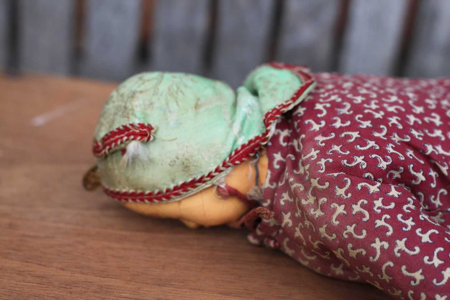 Vintage Chinese carved wood doll with amulet coin – 23cm straw-stuffed cloth body, painted face, cap & jacket c.1930s–50s