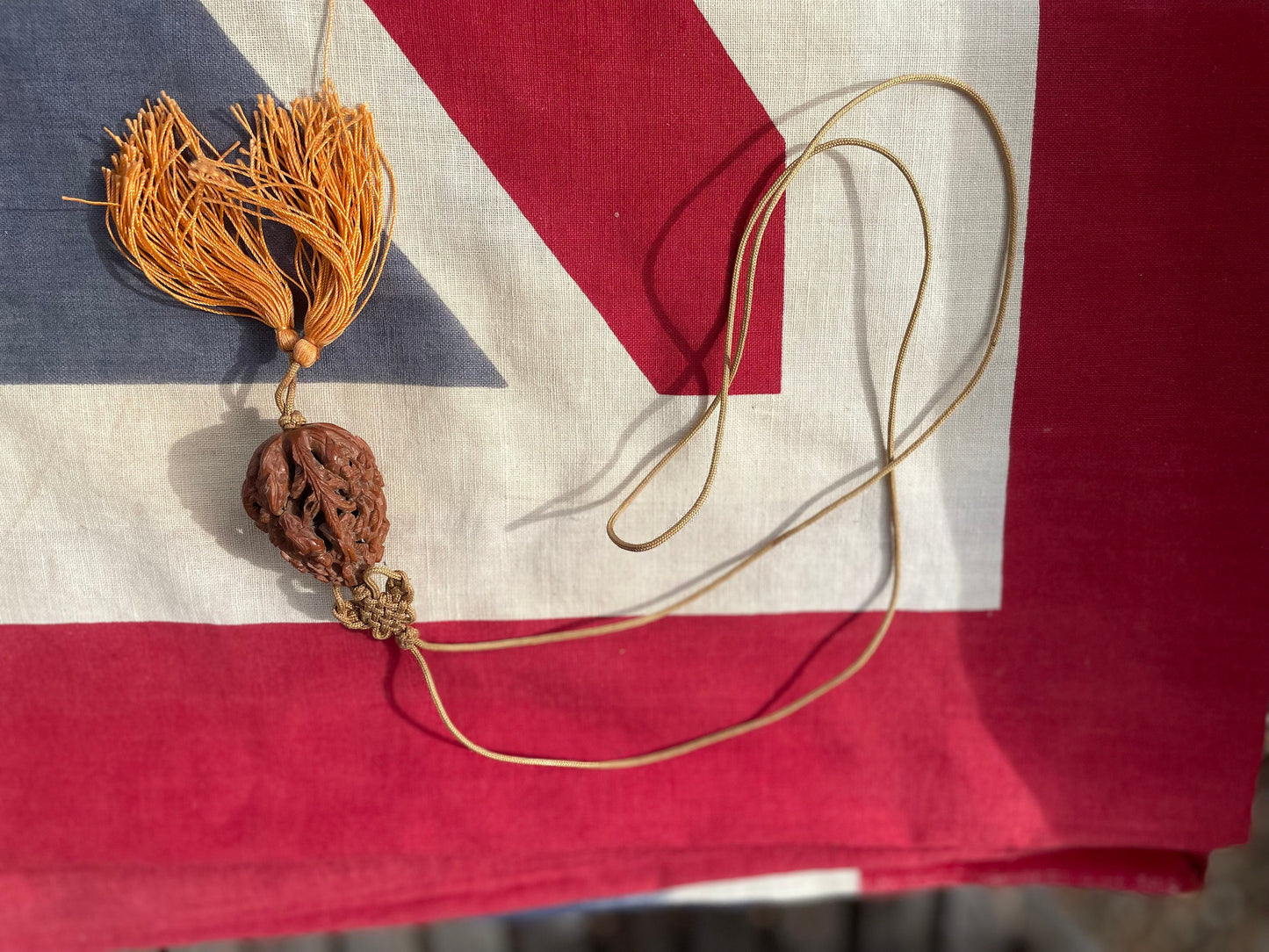 A Hand Carved Chinese Peach Stone Carving on a Silk Cord and Everlasting knot Tassel 42mm Long